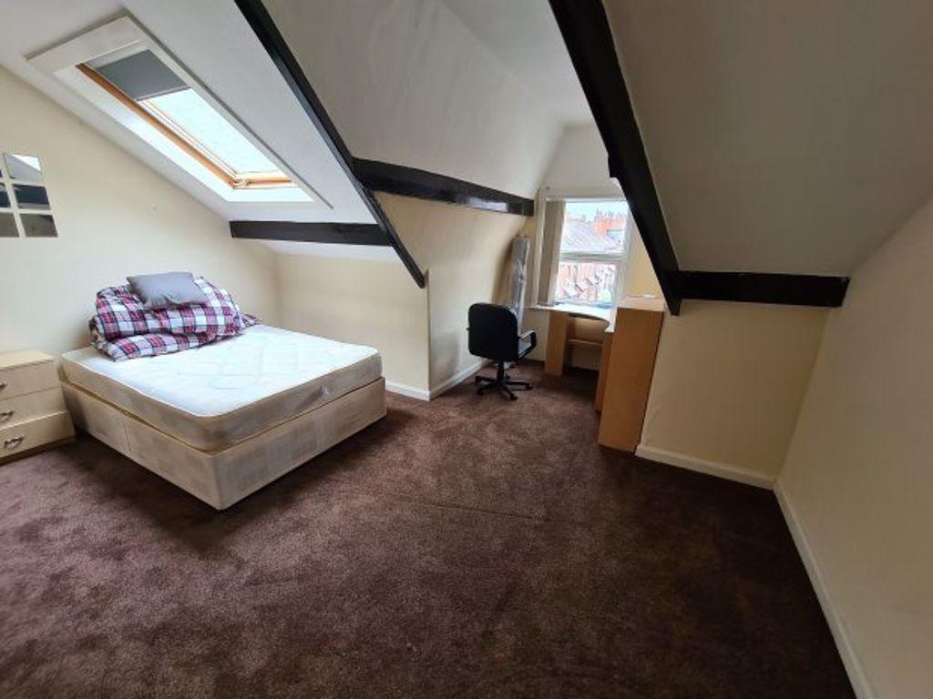 A spacious and well-lit bedroom with a large do...