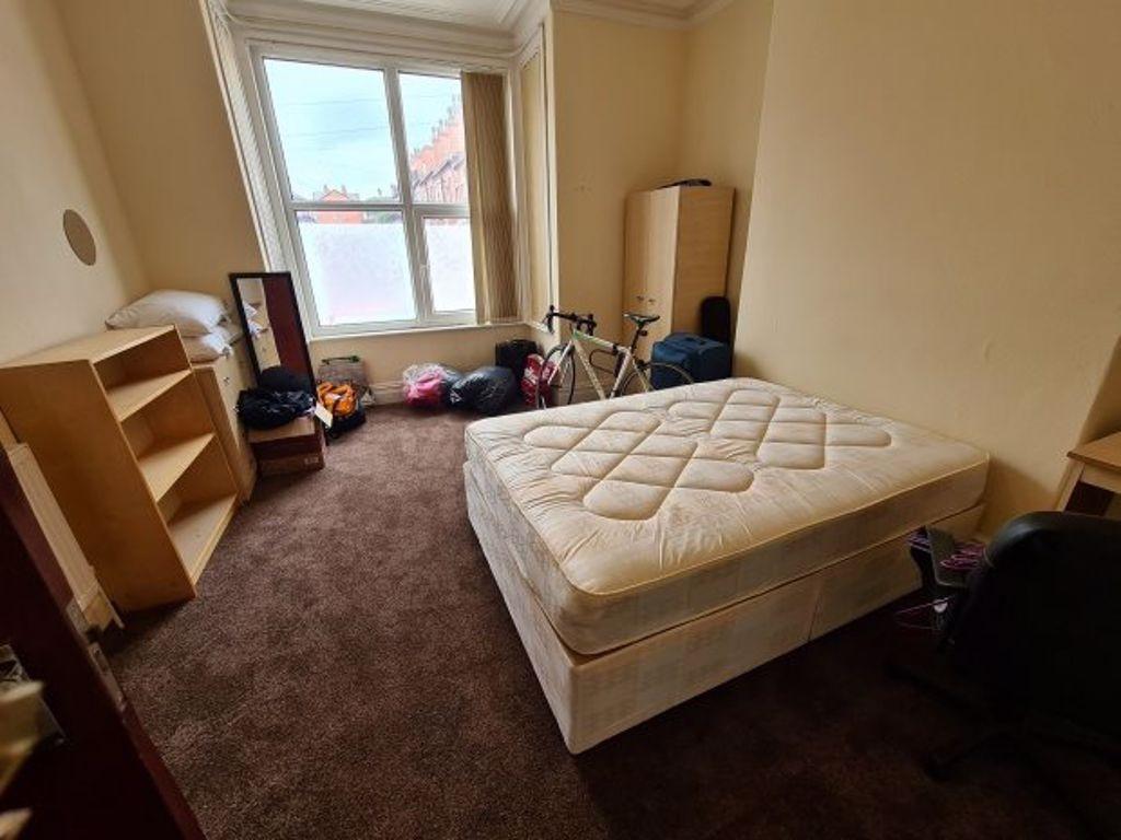 A well-maintained bedroom featuring a comfortab...