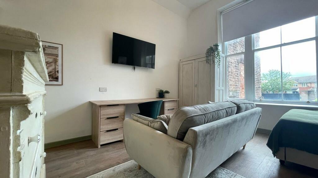 A spacious and bright modern living room featur...