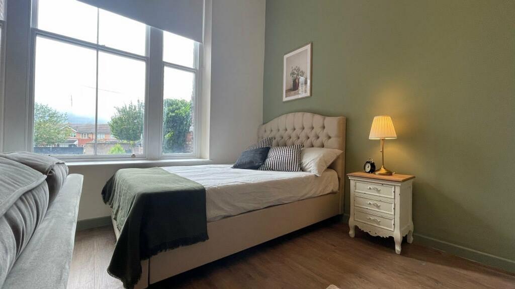 A bright and inviting double bedroom with moder...