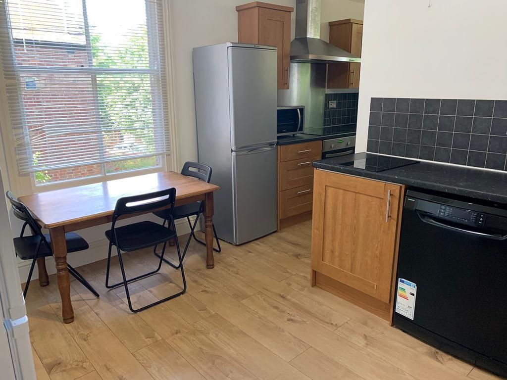 A bright and inviting kitchenette with modern a...