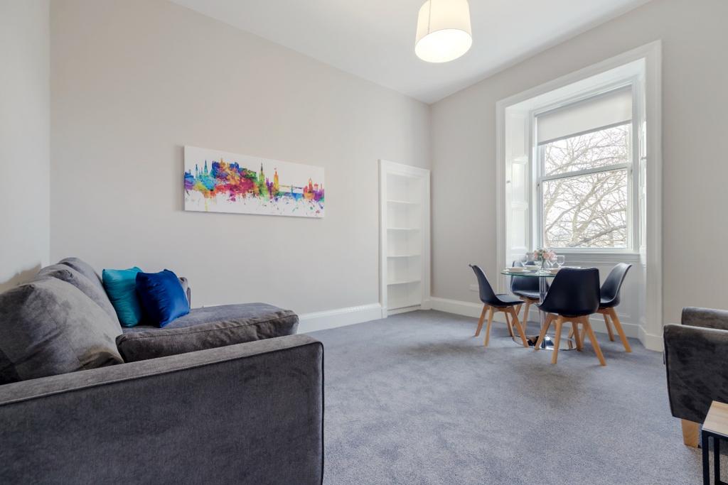 A spacious and modern living room featuring lar...