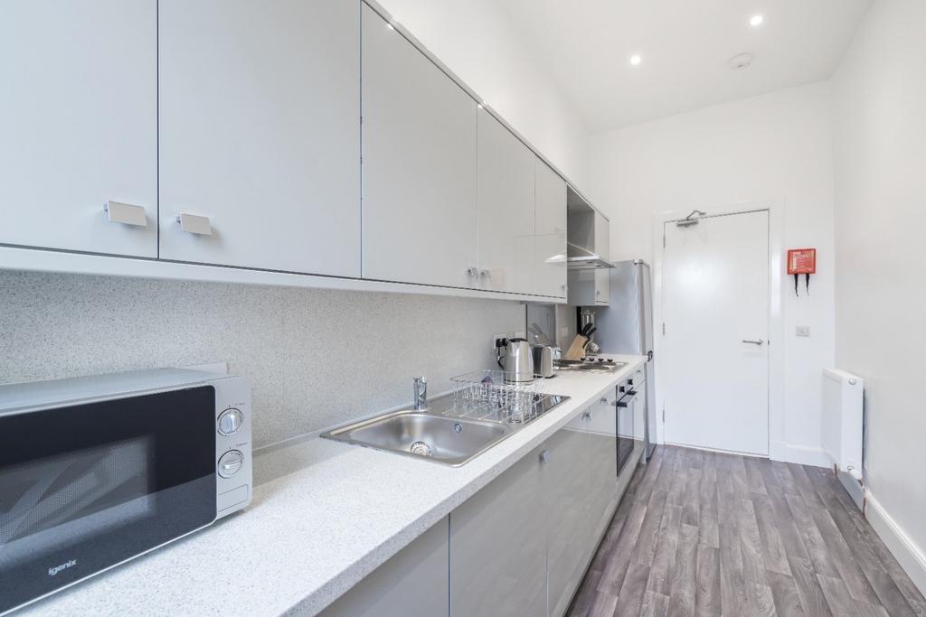 Modern kitchen with sleek cabinetry and ample c...
