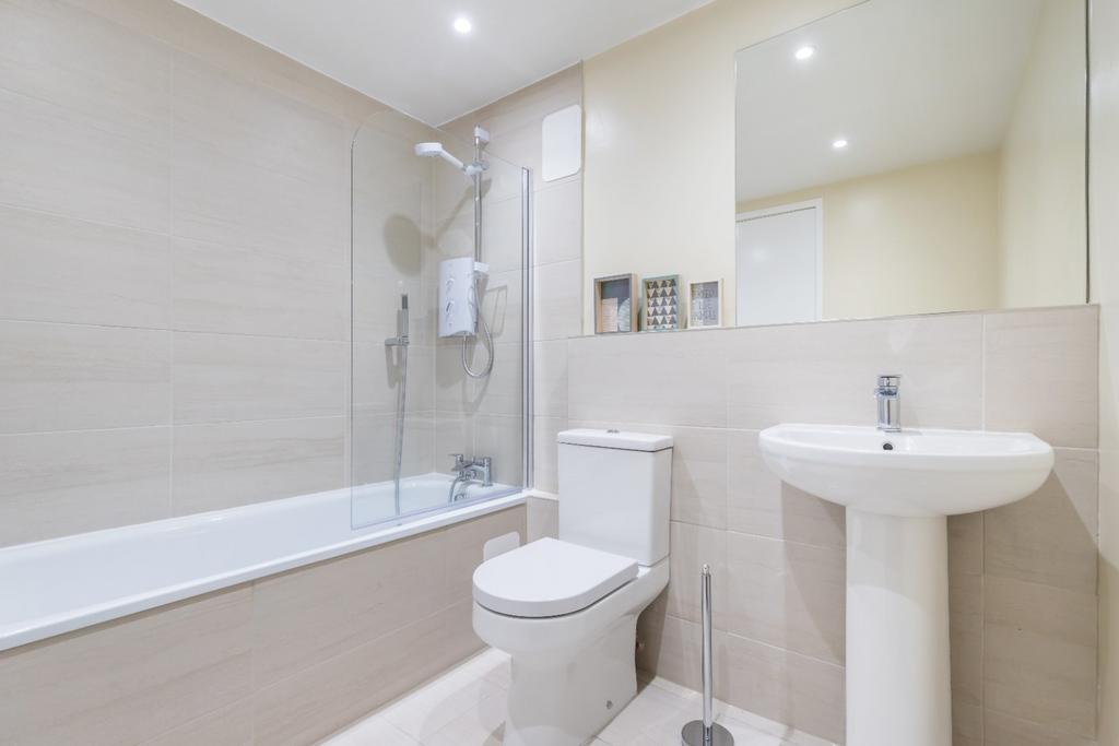 This modern bathroom features a clean design wi...