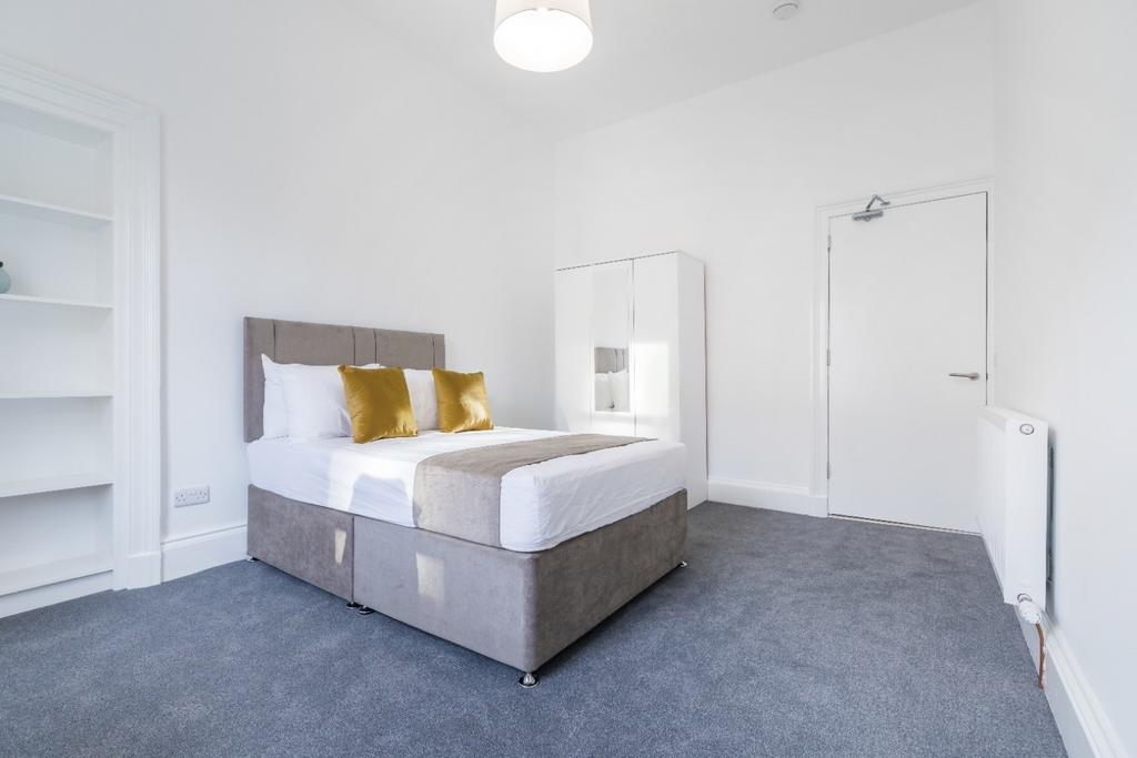 This inviting double bedroom features a cozy la...