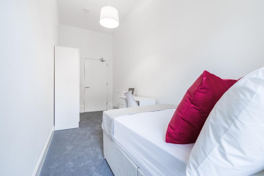 A cozy double bedroom featuring a stylish desig...