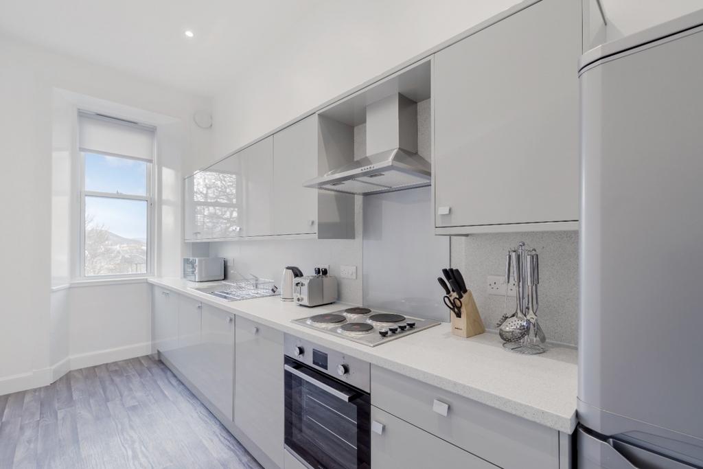 Modern kitchen featuring sleek cabinetry and am...