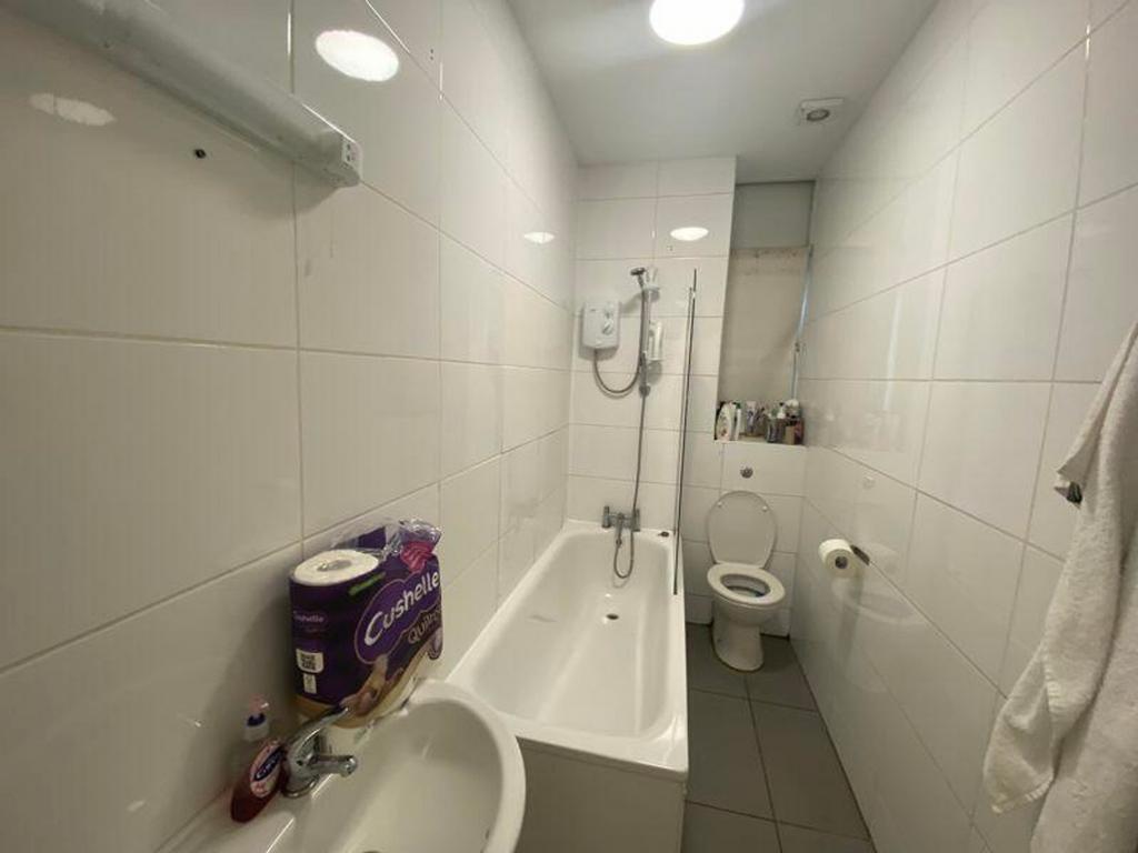 A bright and tidy bathroom featuring modern fix...