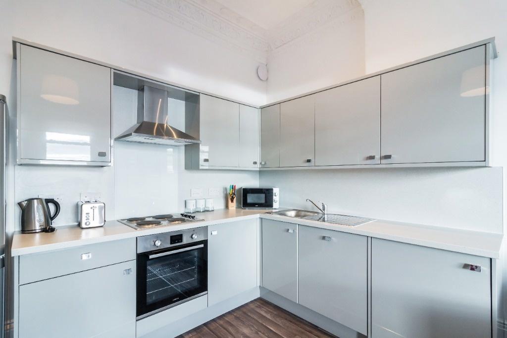 This modern kitchen features sleek cabinetry an...