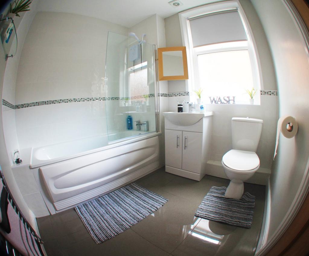 A bright and well-maintained bathroom featuring...