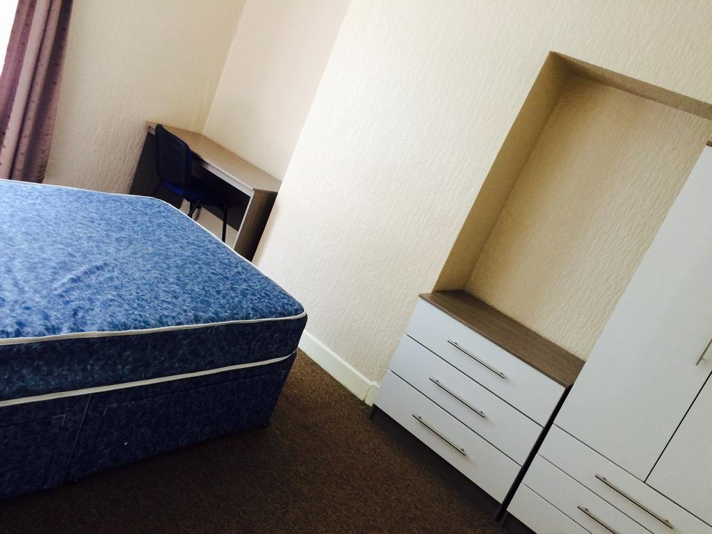 Spacious double bedroom featuring a comfortable...