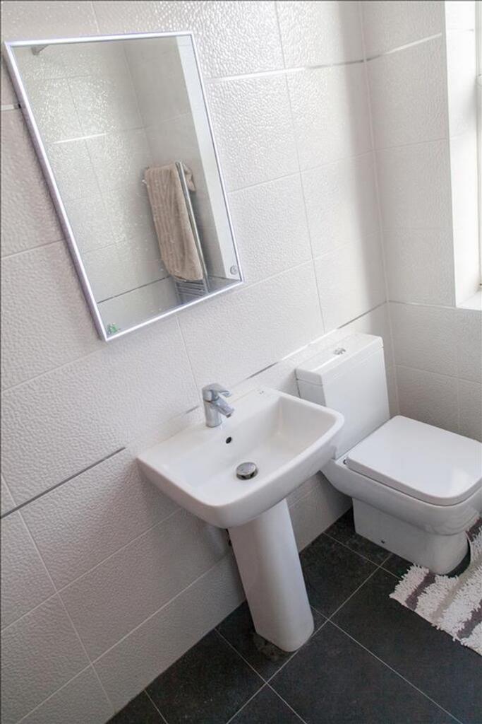 Bright and modern bathroom featuring sleek fixt...
