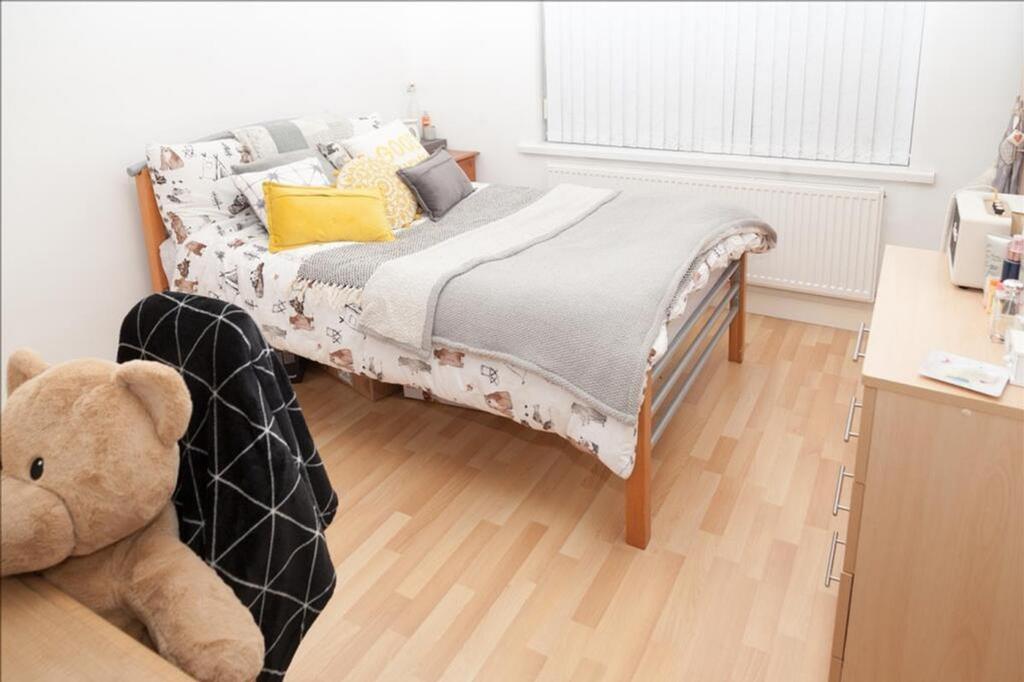 This inviting double bedroom features a comfort...