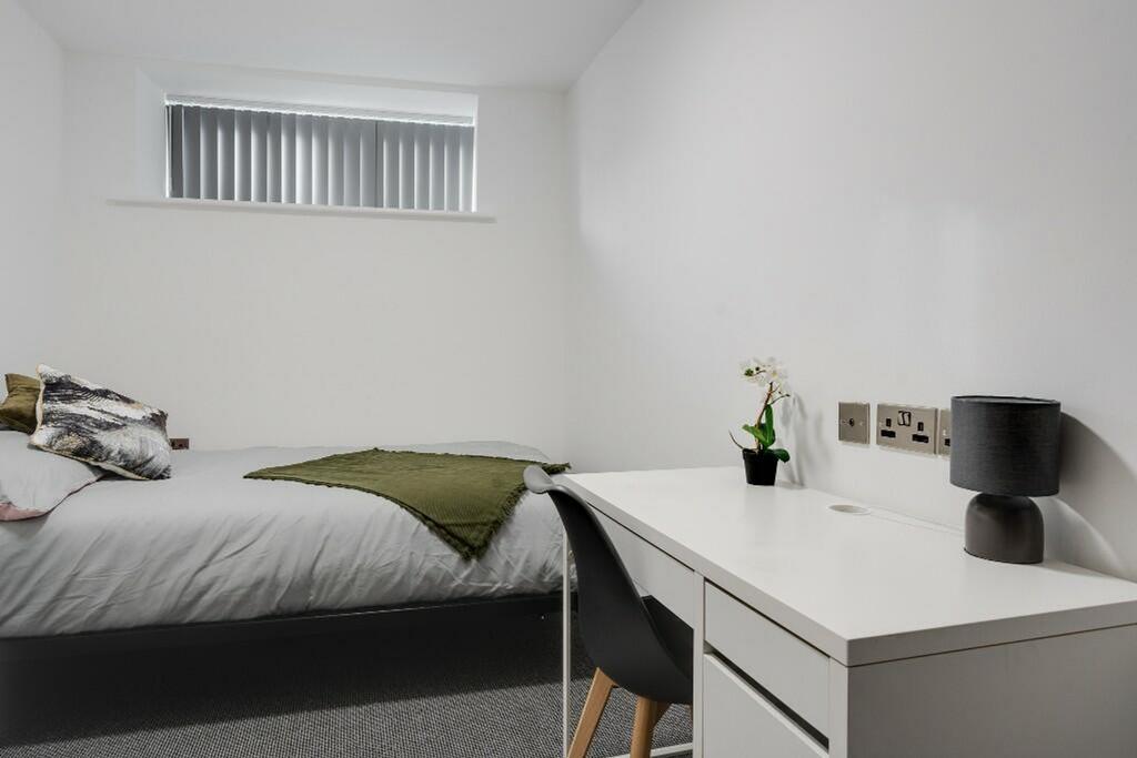 This inviting double bedroom features a comfort...