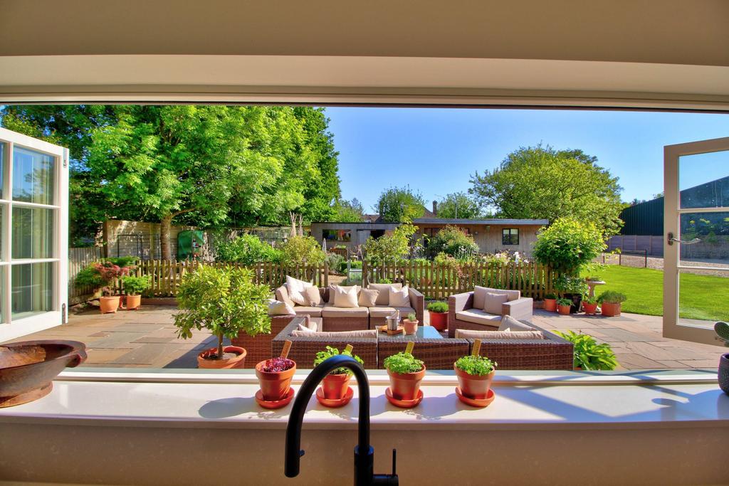 Bifold windows overlooking sunny kitchen garden