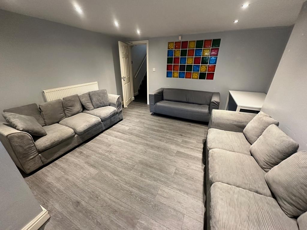 Spacious and inviting living room featuring com...