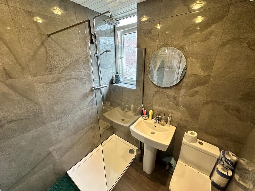 This modern bathroom features a spacious shower...