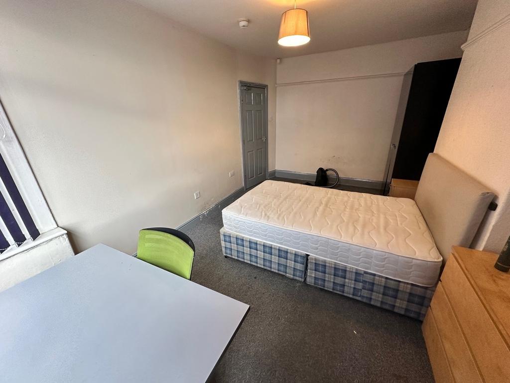 Spacious double bedroom featuring a comfortable...