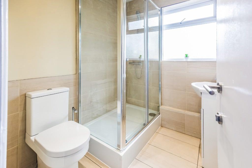 This modern bathroom features a sleek shower en...