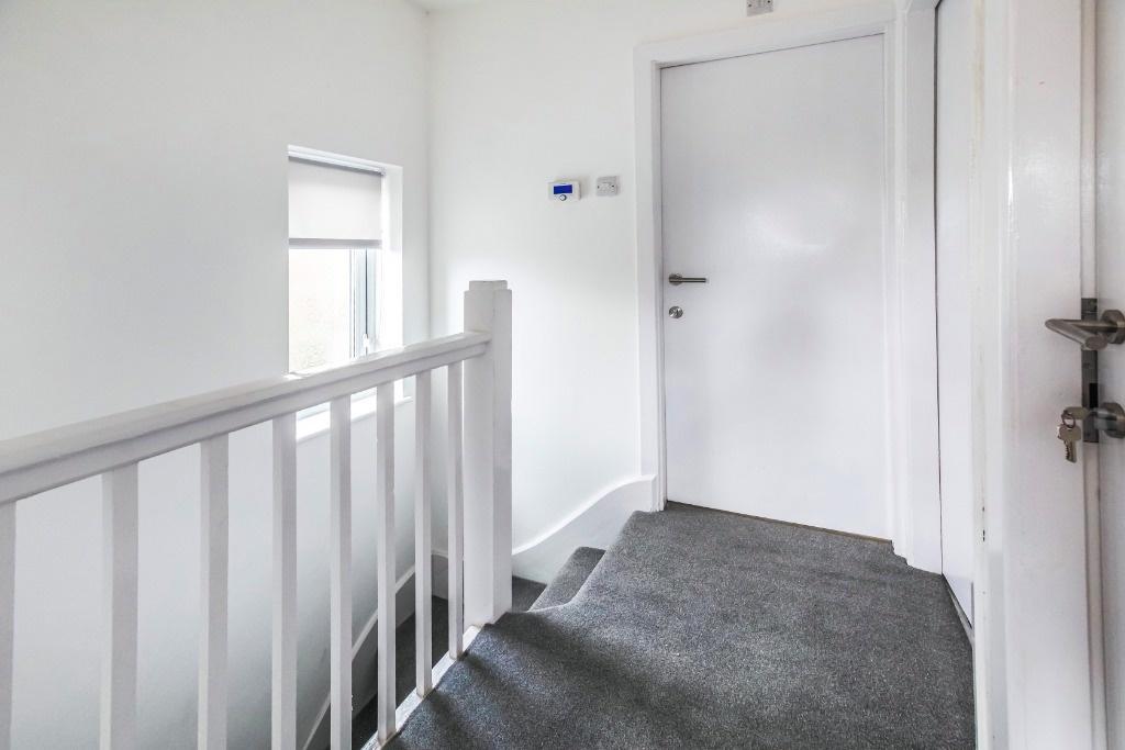 Bright and inviting hallway with modern finishe...