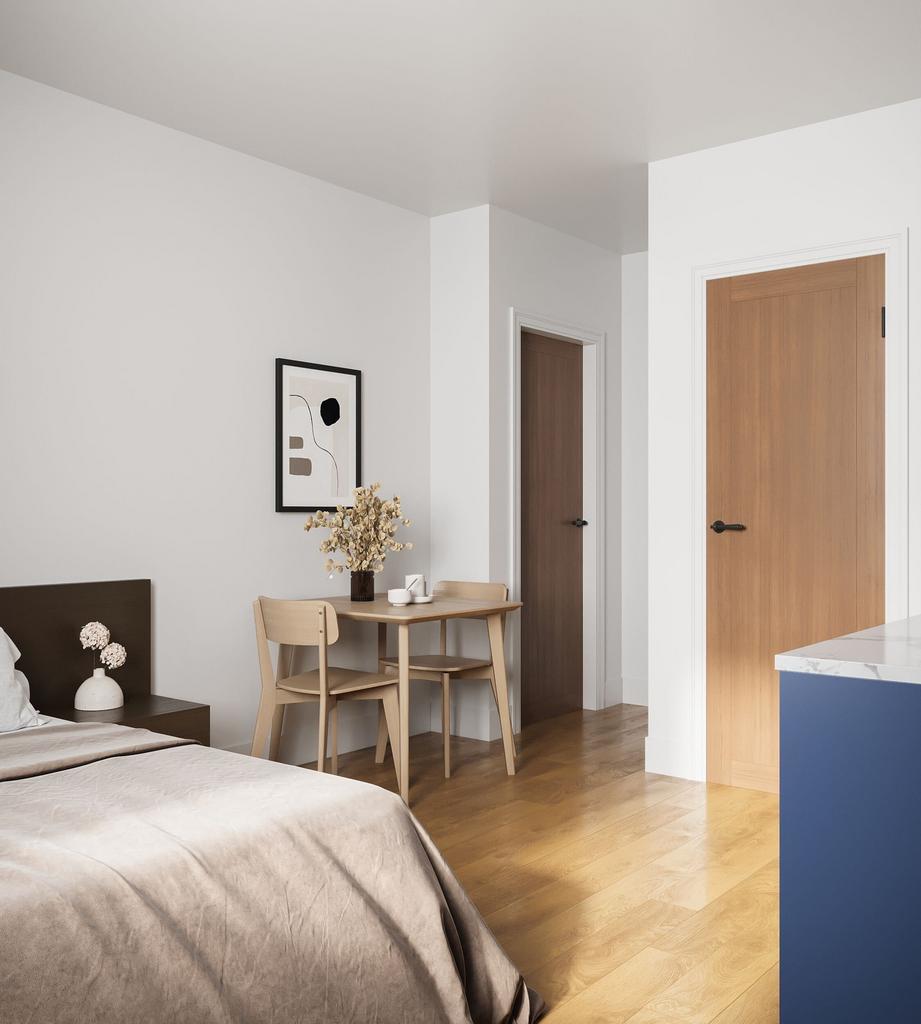 A modern and tidy double bedroom featuring a be...