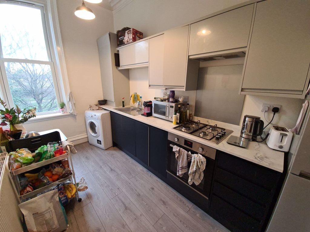 Bright and modern kitchen featuring ample count...