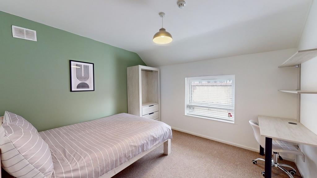 A bright and inviting double bedroom featuring ...