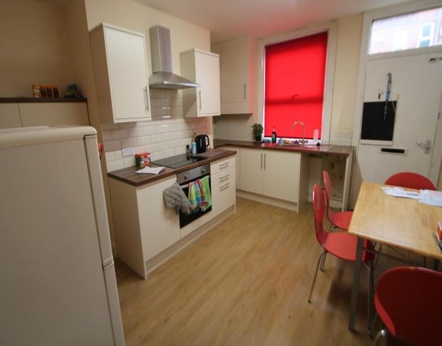 Bright and modern kitchen featuring clean woode...
