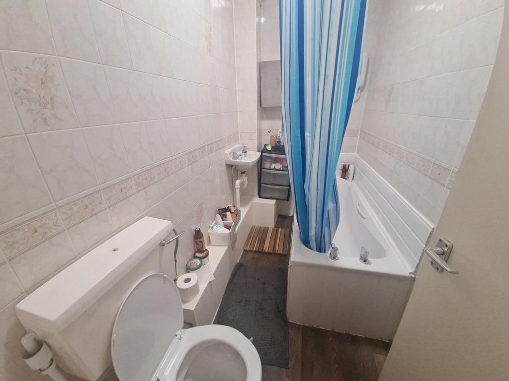 A neat and functional bathroom featuring a whit...