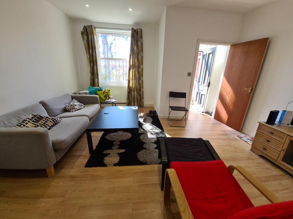 A spacious and welcoming living room featuring ...
