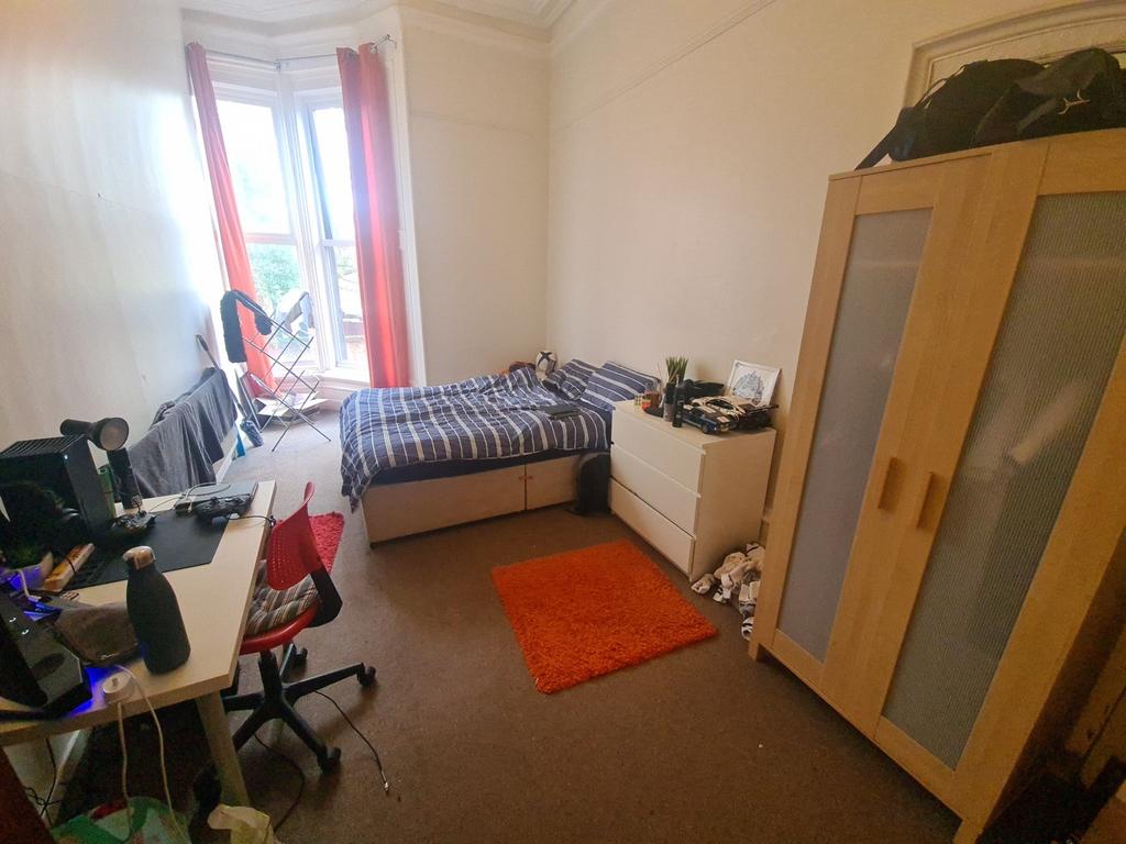 Bright and cozy single bedroom featuring a larg...