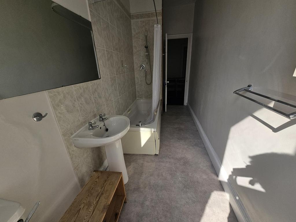 A clean, well-maintained bathroom with a sink, ...