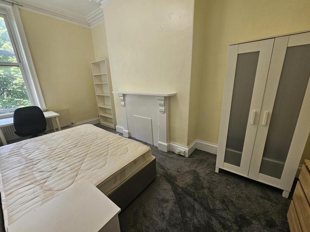 A welcoming double bedroom featuring a double b...