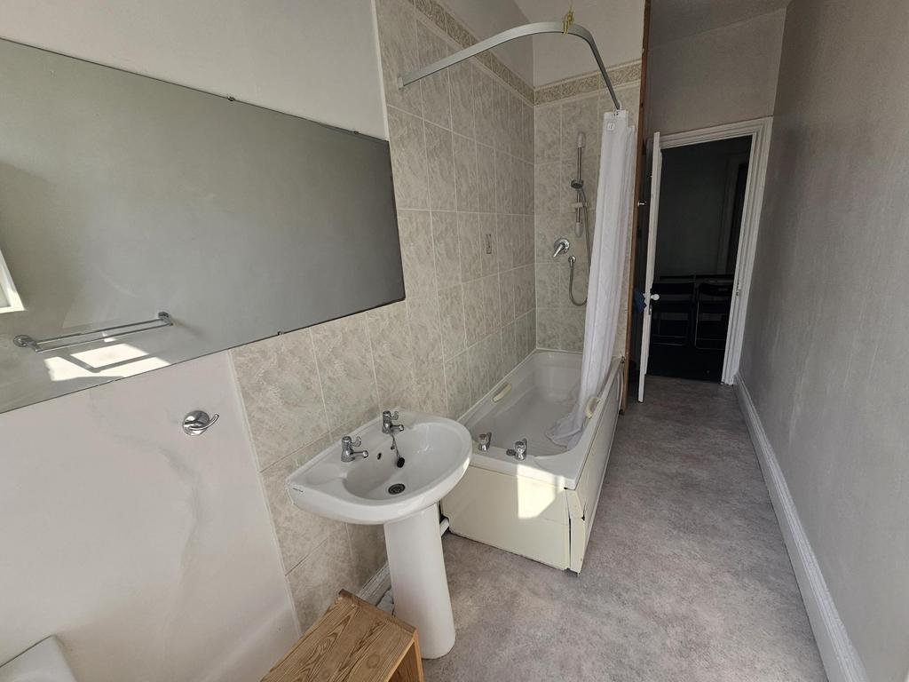 A well-maintained bathroom featuring a bathtub ...