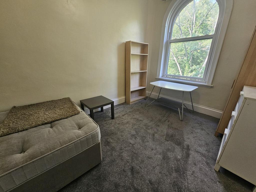 Cozy living room with a comfortable sofa, a sma...
