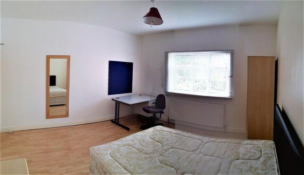 Bright and tidy double bedroom featuring a comf...