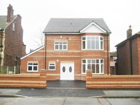 A well-maintained detached brick house with a n...