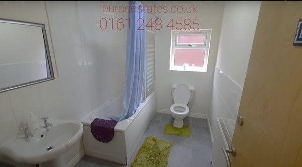 A bright bathroom suite featuring a white batht...