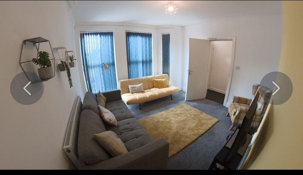 Bright, modern living room with two comfortable...