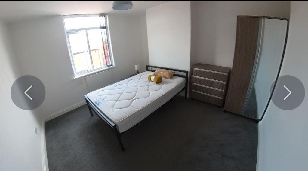 Bright, simply furnished double bedroom with a ...