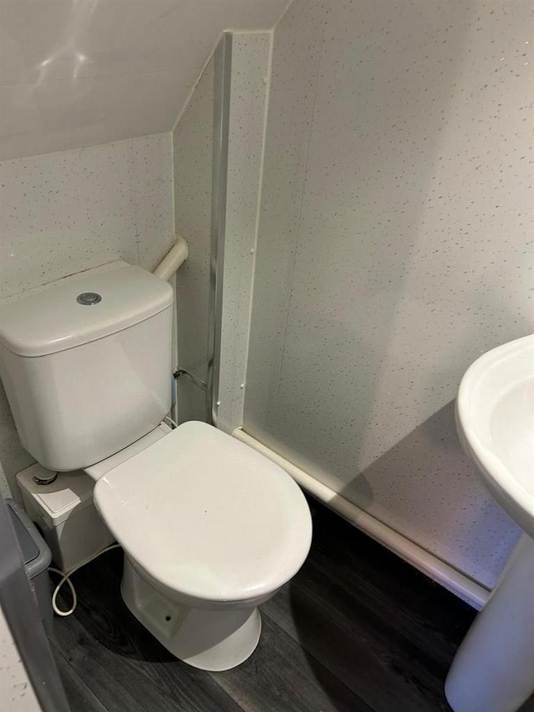 Compact, tidy bathroom featuring a close-couple...