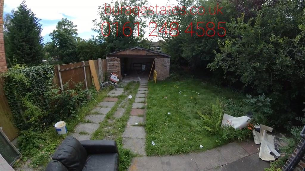 A spacious garden with a paved walkway leading ...