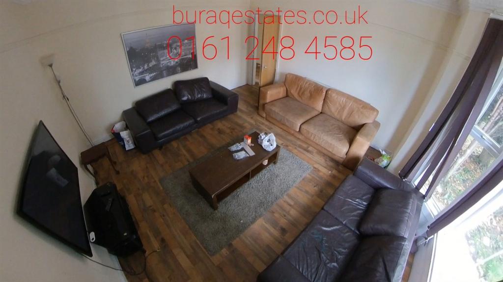 A cozy living room featuring three sofas arrang...