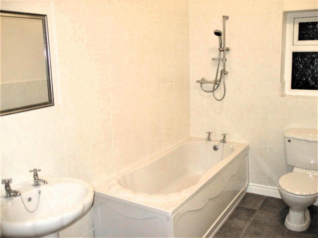 A clean and functional bathroom suite featuring...