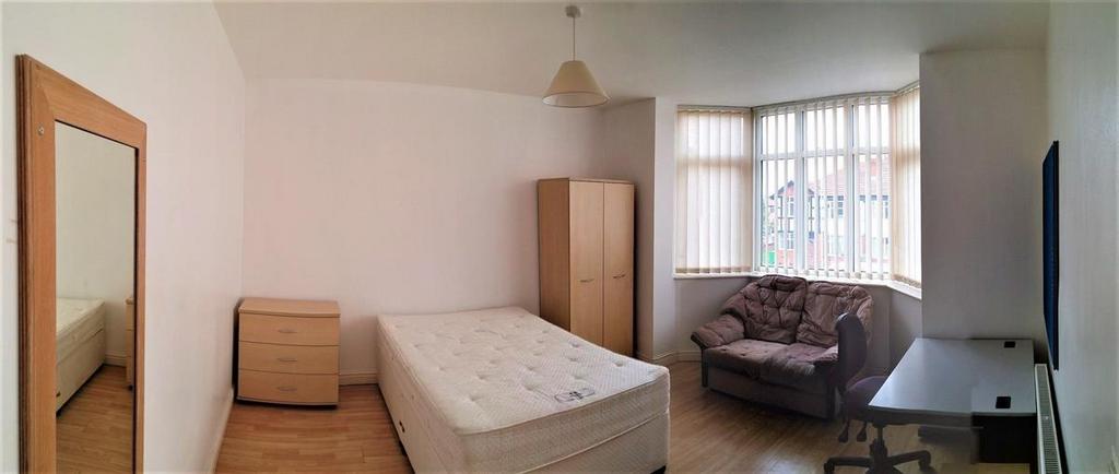 A bright and tidy single bedroom featuring a co...