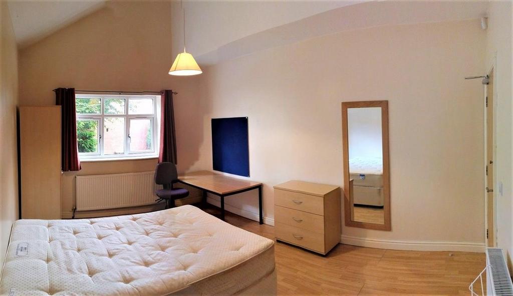 Bright and spacious master bedroom featuring a ...