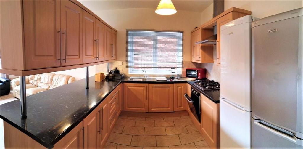 A modern kitchen featuring ample wooden cabinet...