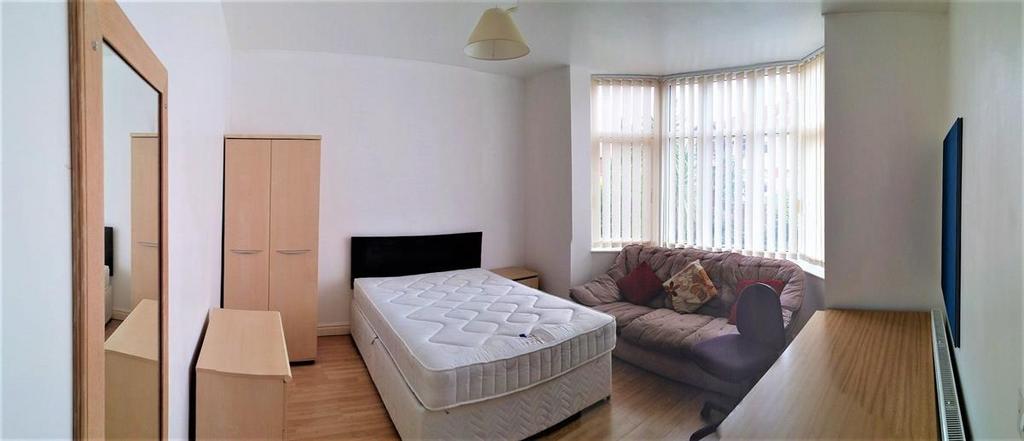 A bright double bedroom featuring a comfortable...