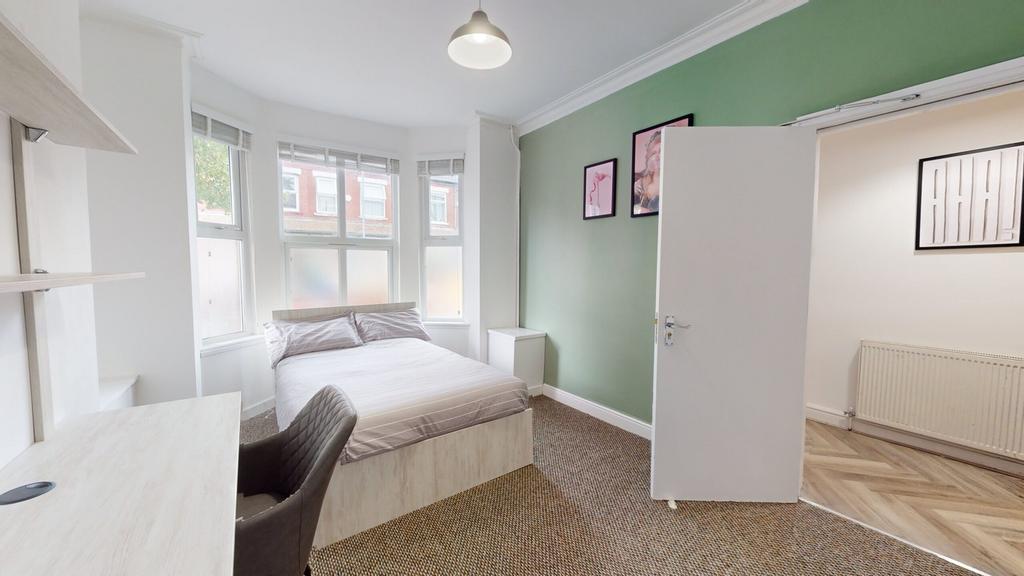 A bright and inviting double bedroom with ample...