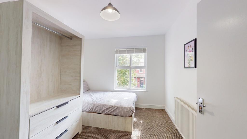 A bright and inviting double bedroom with ample...